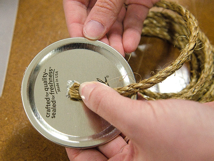 Glue the rope to the center of your canning lid.